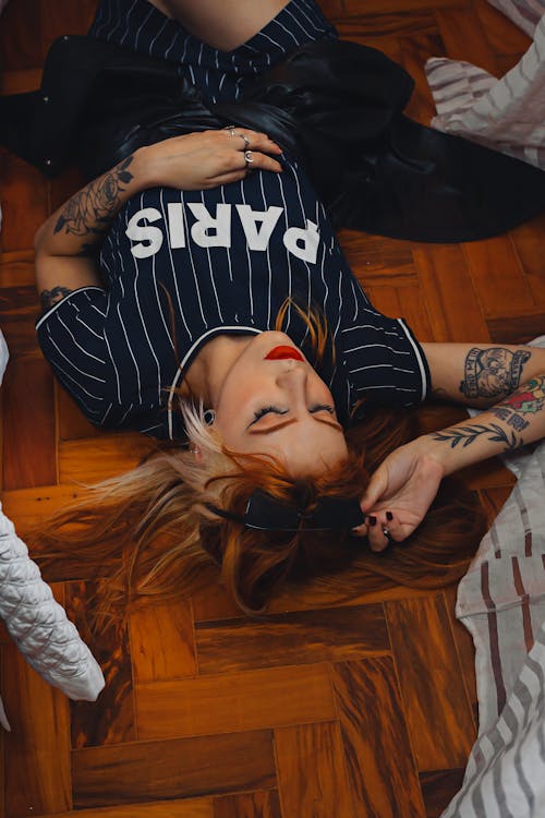 Woman with Tattoos Lying Down on Floor