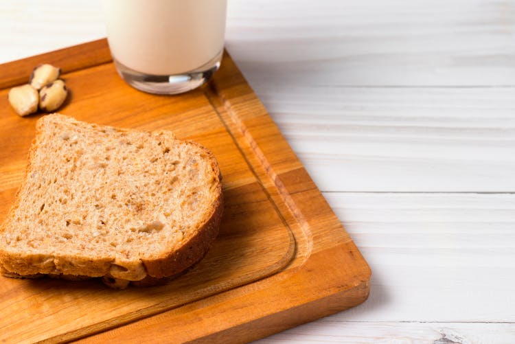 Wheat Bread Slice On Brown Wooden Board