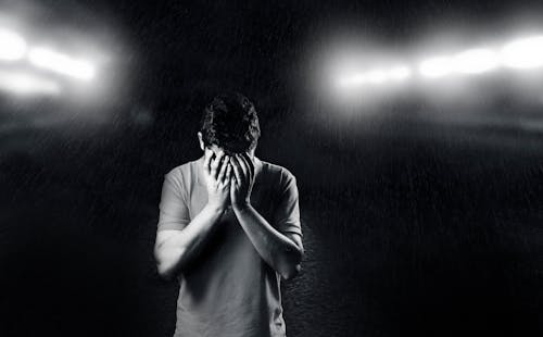 Monochrome Photo of Man Covering His Face