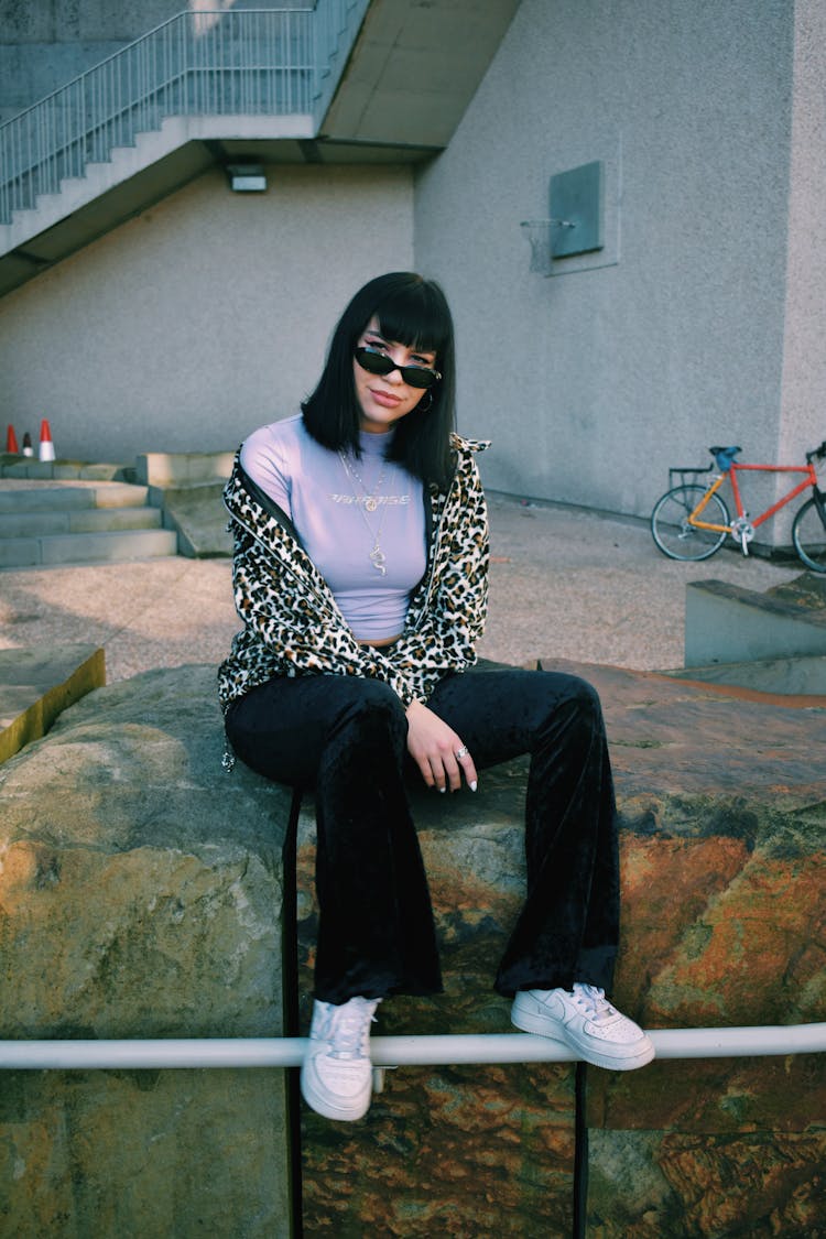 Woman Sitting On Ledge