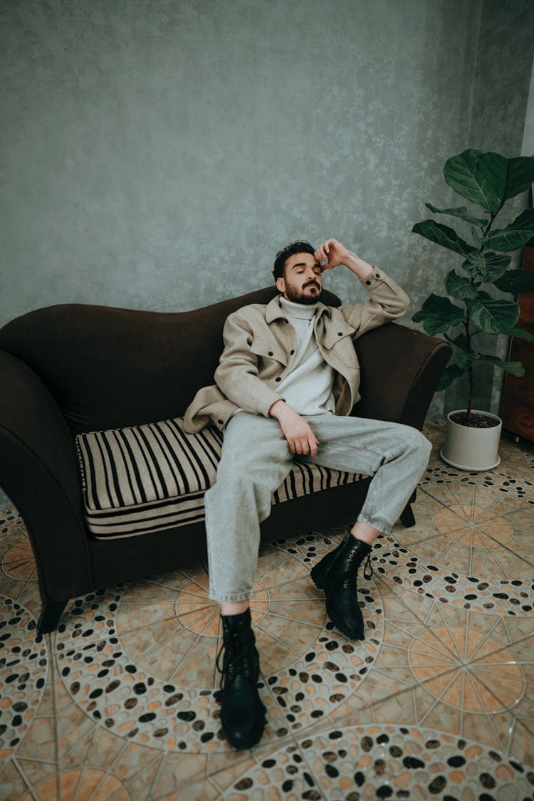 Fashionable Man Sitting On A Couch 