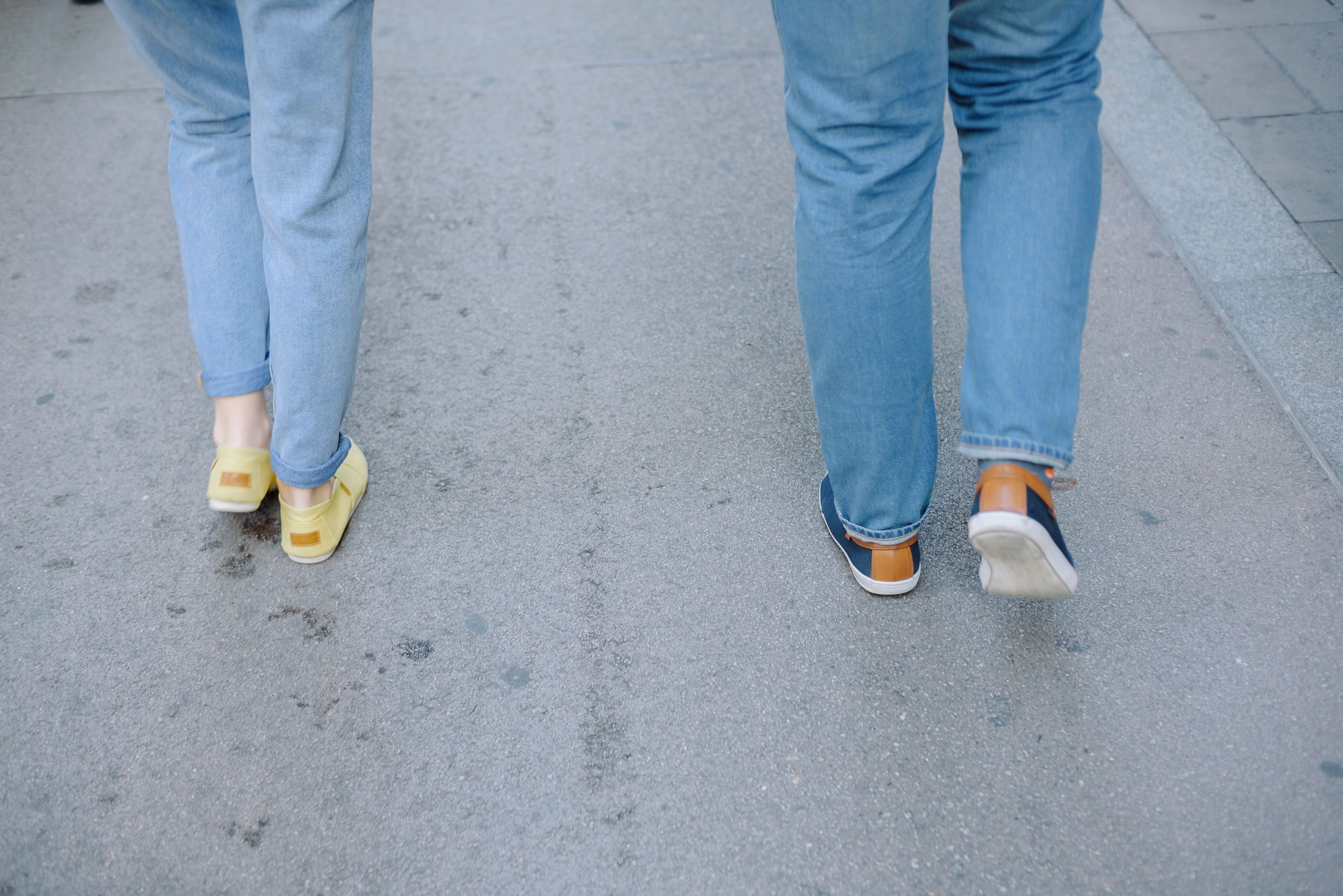 Pairs of people walking together down a city street