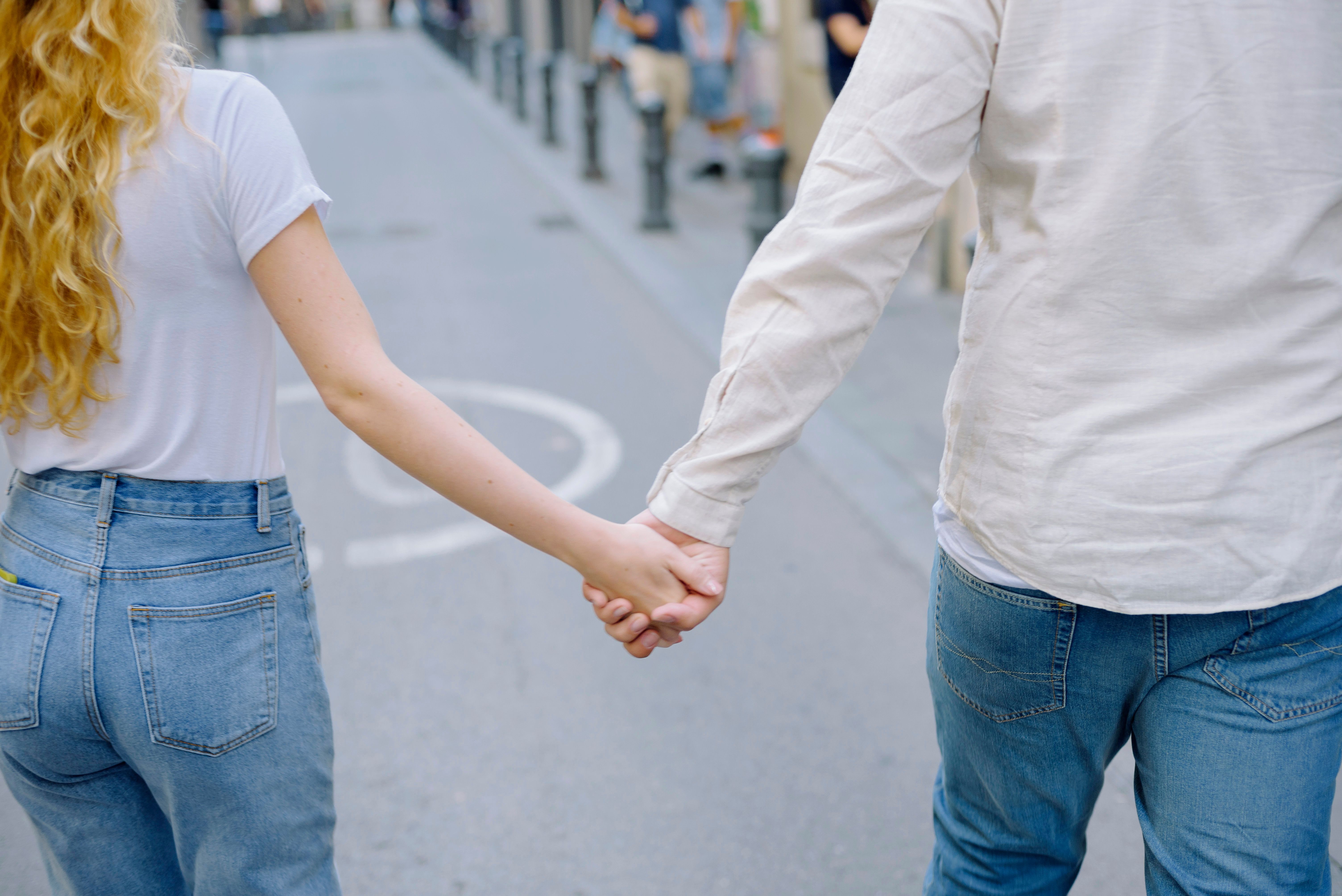 Couple Holding Hands and Walking on Street · Free Stock Photo