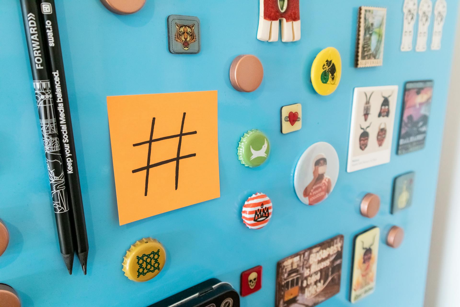 Hashtag Sign on a Memo Card and Stickers on Blue Background