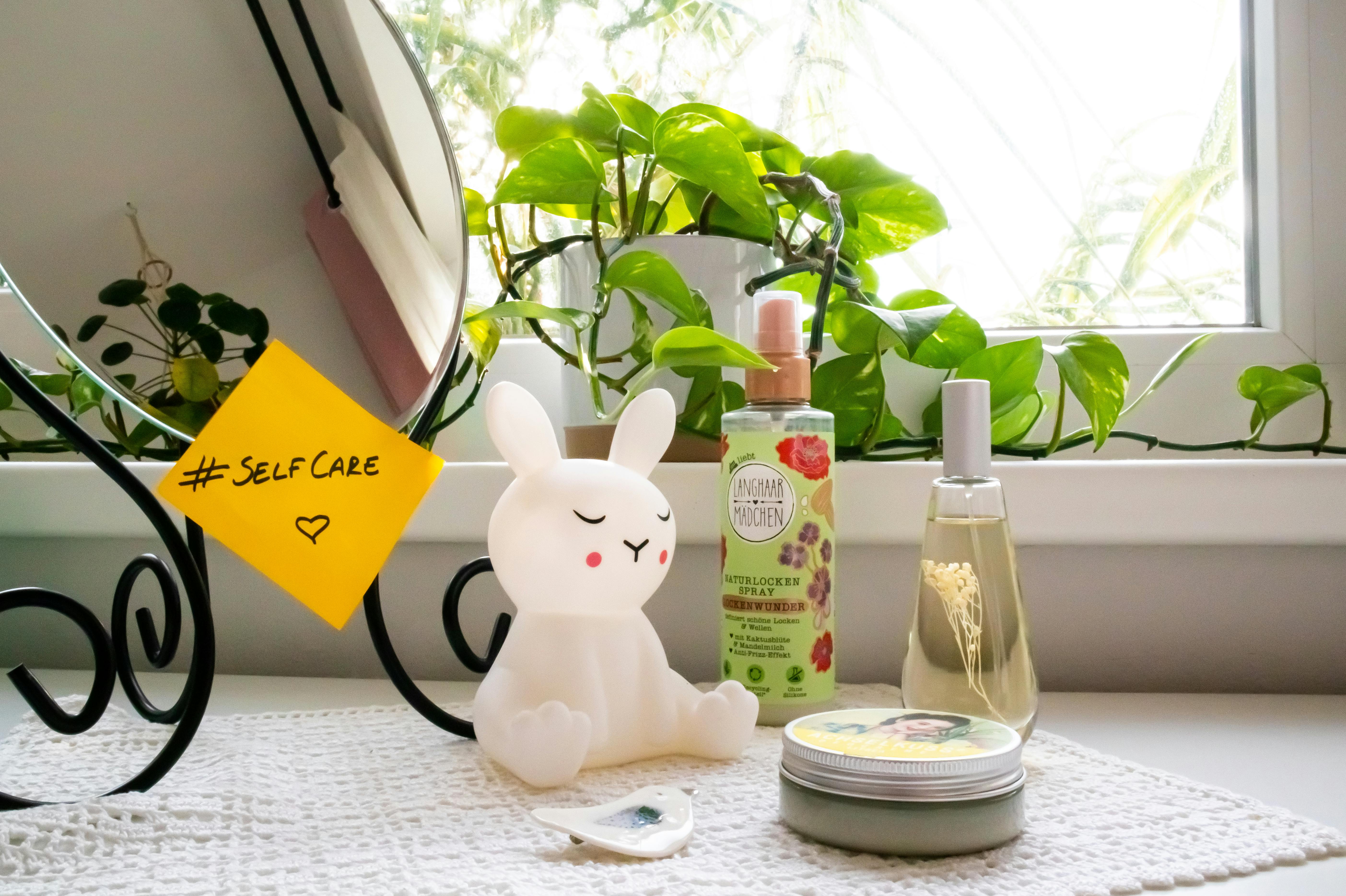 A soothing self-care corner with a bunny lamp, cosmetics, and a mirror, perfect for a relaxing routine.
