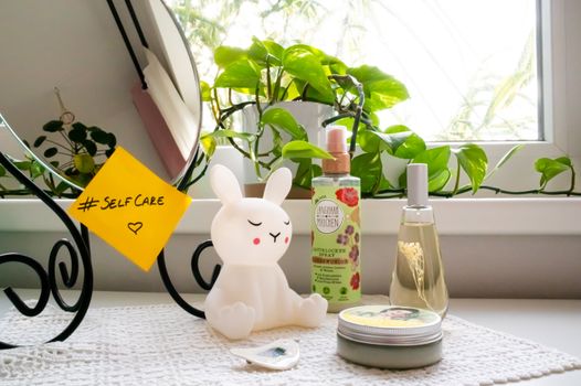 A soothing self-care corner with a bunny lamp, cosmetics, and a mirror, perfect for a relaxing routine.