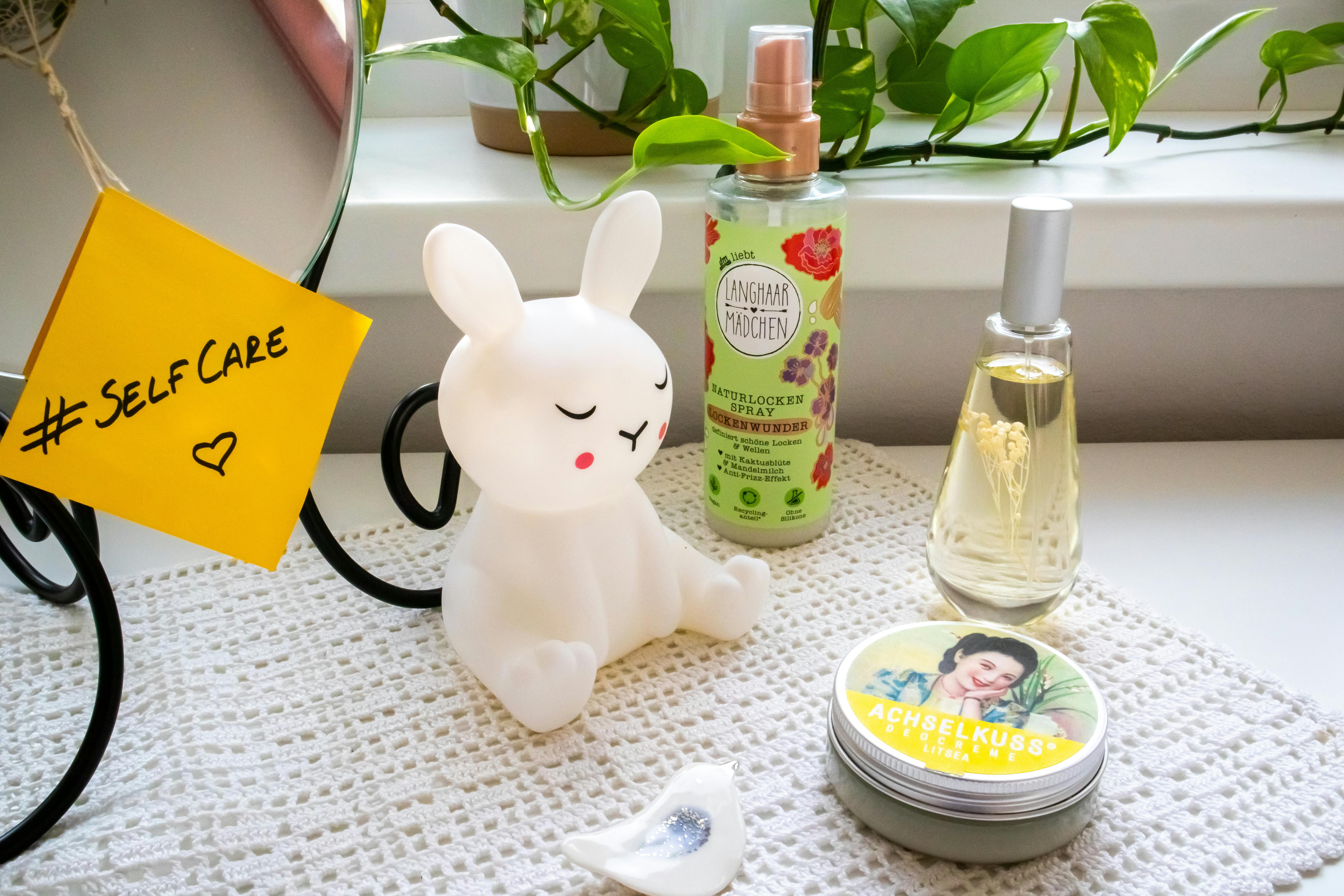 Modern self-care setup featuring beauty products, a mirror, and plant decor.