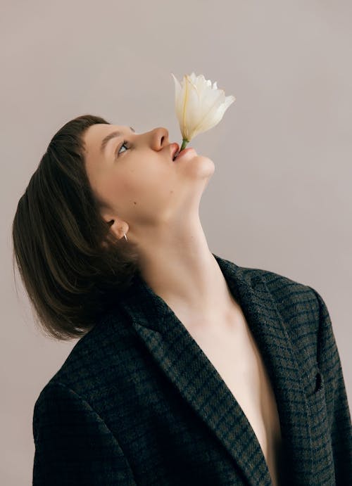 Beautiful Woman with Flower in Mouth