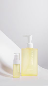 Elegant white and yellow skincare bottles in a minimalist setting emphasizing beauty and self-care.
