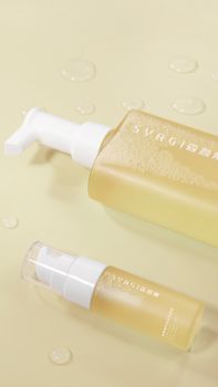Minimalist flat lay of two skincare pump bottles on a light background.