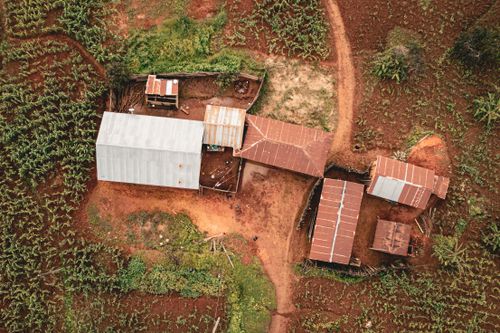 Free Drone shot of a rustic farm and fields in Makete, Tanzania. Stock Photo