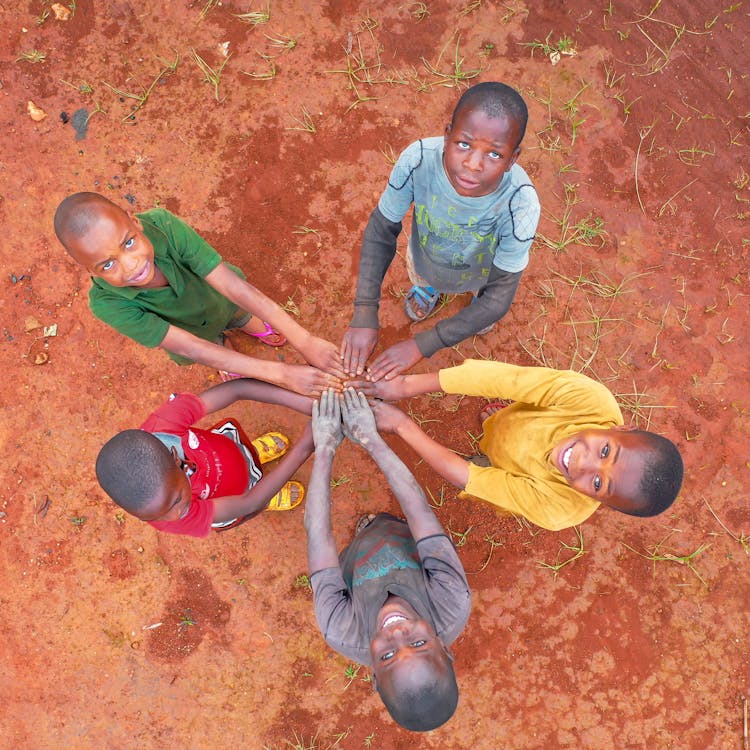 Top View Of Boys In Colorful Shirts Holding Hands