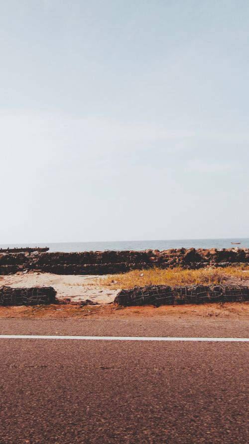 Free A scenic coastal road near the ocean in Rameswaram, India, showcasing natural beauty. Stock Photo