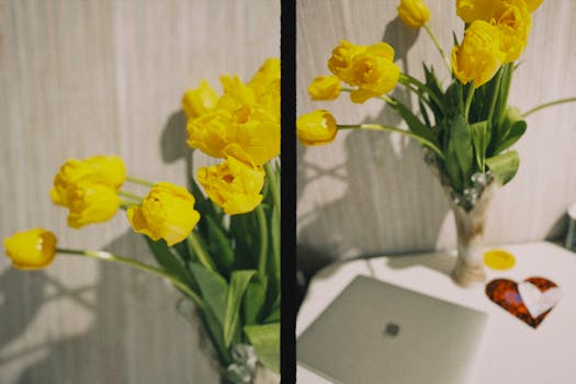 Vibrant yellow tulips in a glass vase add elegance to a desktop setting.