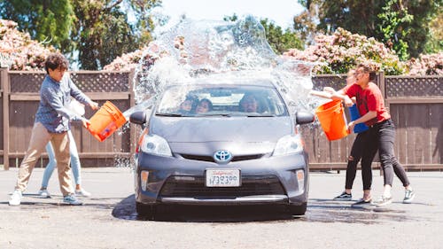 Free Four Children Washing Silver Toyota Prius Stock Photo