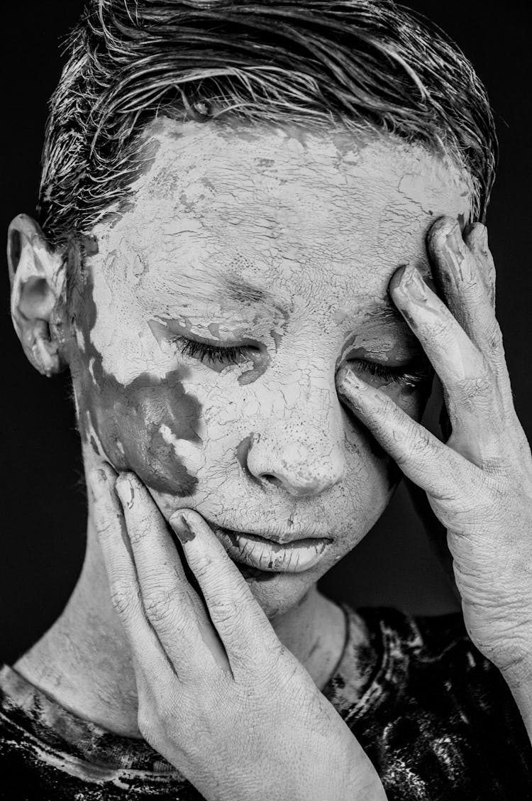 Portrait Of A Young Boy With Paint Patches On His Face 