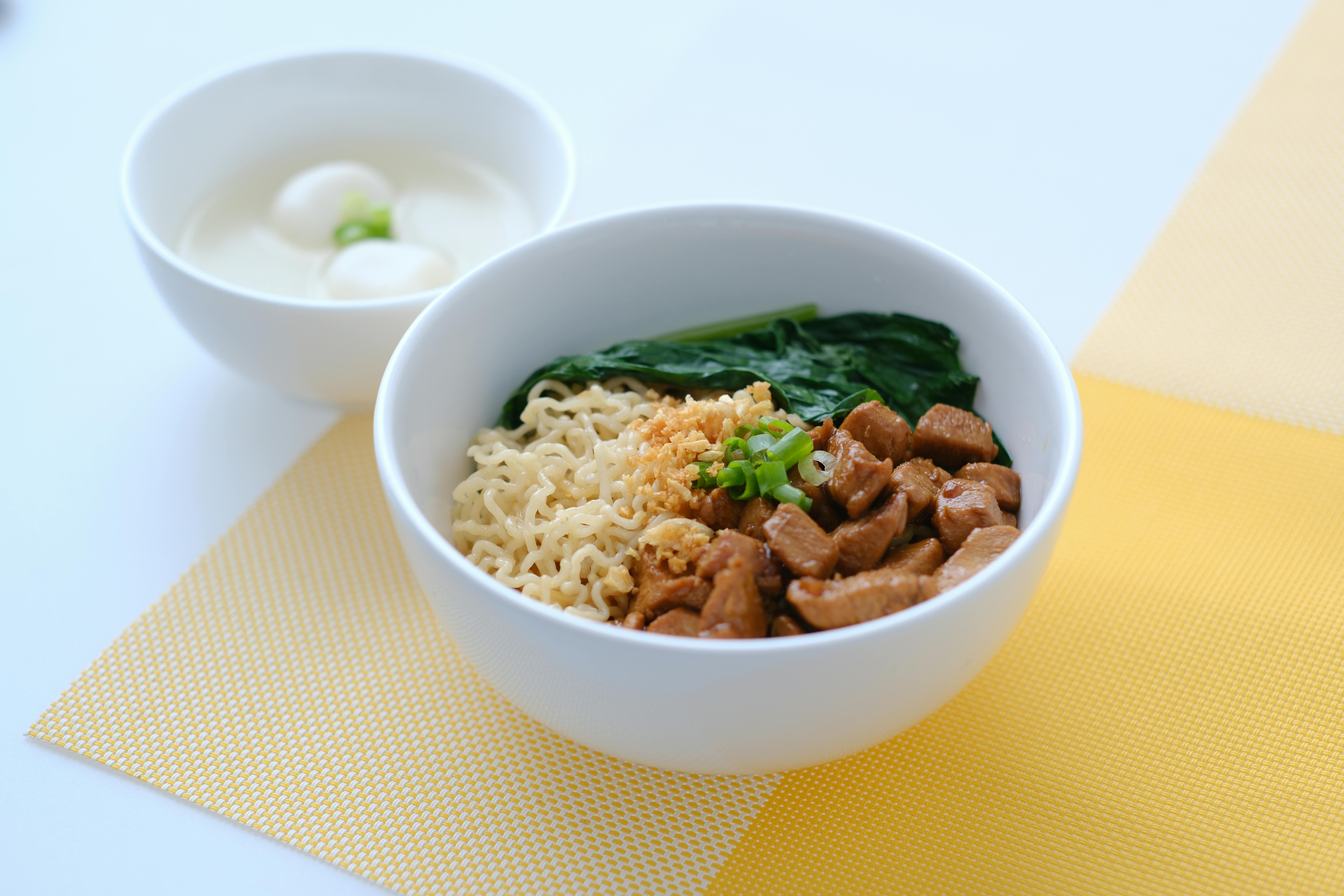 A delicious noodle bowl with beef, spinach, and eggs, perfect for a satisfying meal.