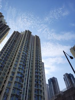 Low angle view of tall skyscrapers with a dramatic sky backdrop, showcasing urban architecture.