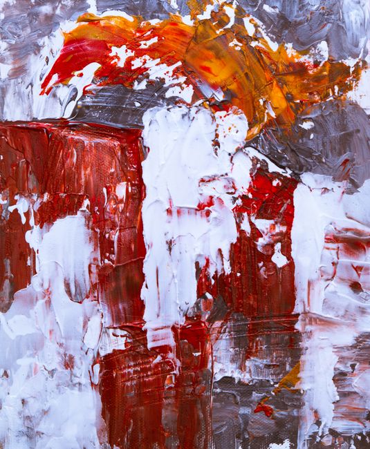 Colorful abstract artwork with acrylics showcasing vivid red, orange, and white textures.