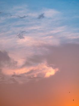 A stunning sunset sky with vibrant orange and pink hues blending into blue, capturing the essence of a peaceful evening.
