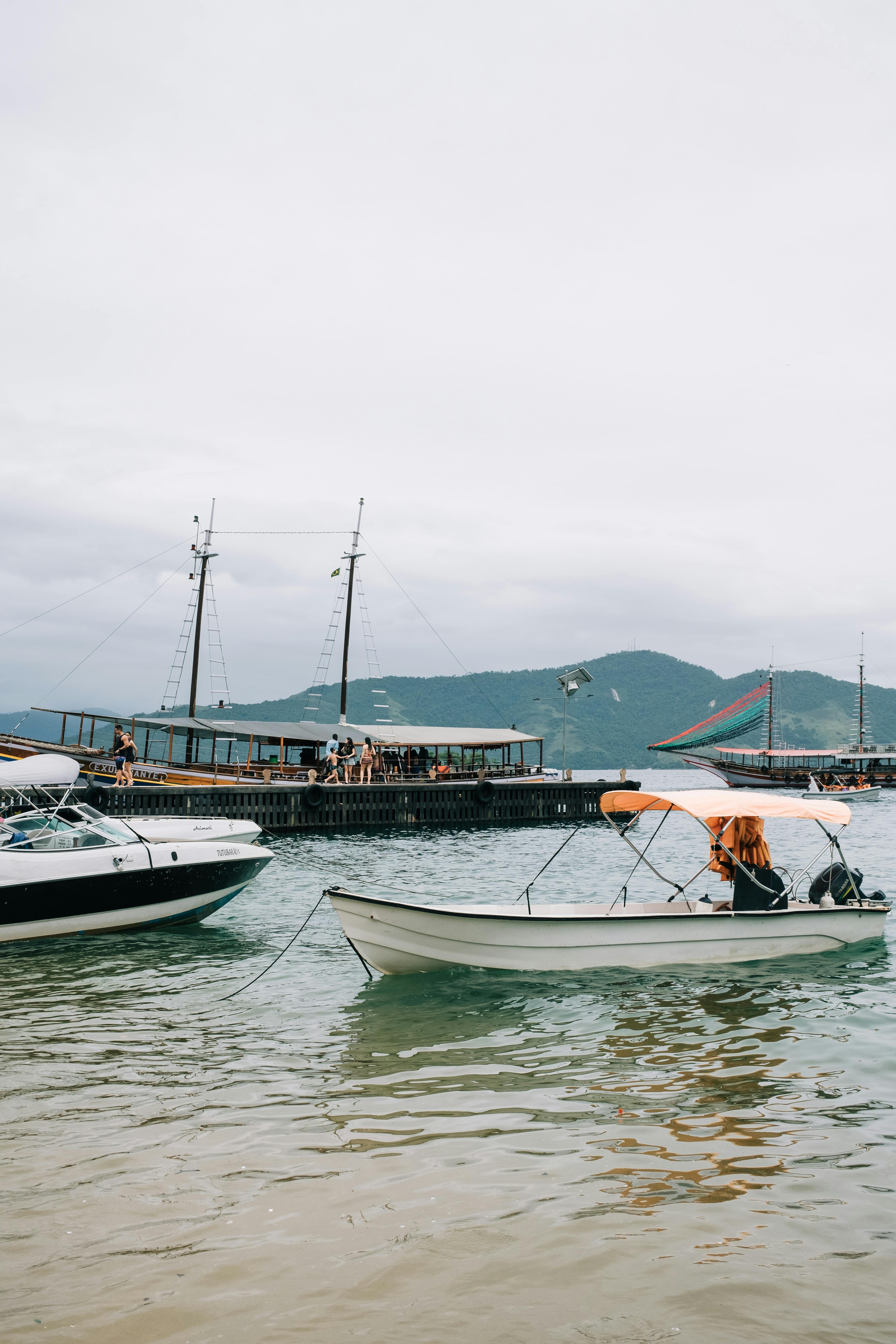 Scenic view of boats in Angra dos Reis harbor with mountains in the background.
