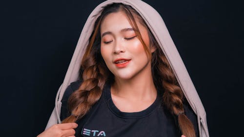 Studio Shoot of a Woman with Braided Hair Wearing a Lilac Hood