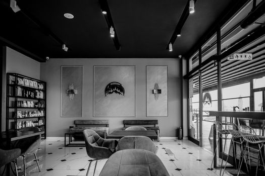 Elegant black and white interior view of a modern café in Istanbul, featuring stylish furniture and decor.