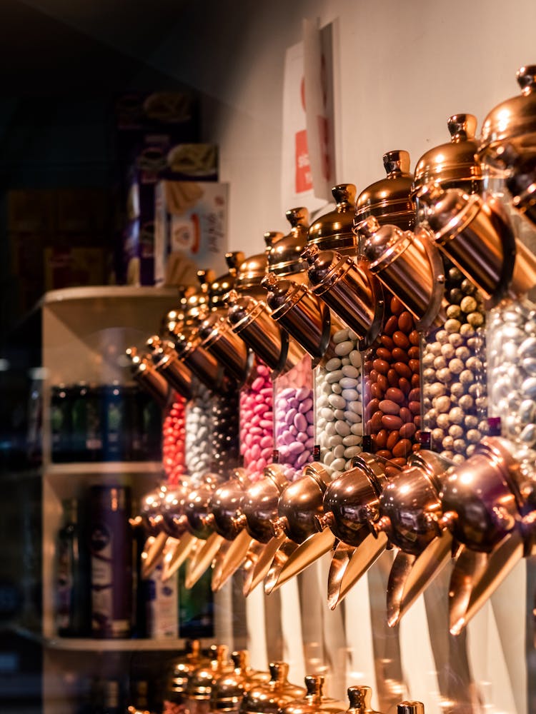 Close-up Of Dispensers With Candy In A Candy Shop 