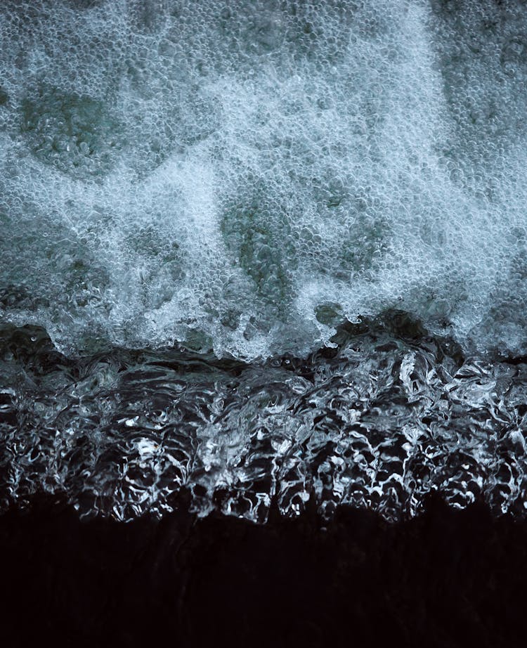 Close-up Of Clear Water Washing Up The Beach 