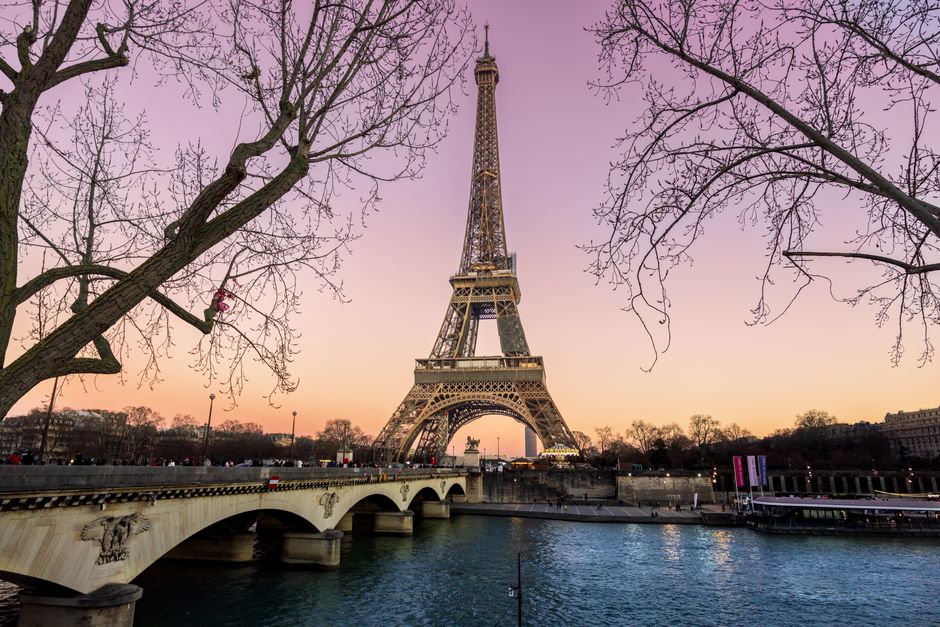 Stunning view of the Eiffel Tower and Pont d'Iéna Bridge at sunset in Paris, France.
