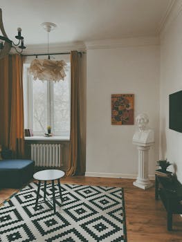 A contemporary living room featuring chic furnishings and a classic sculpture in a Minsk apartment.