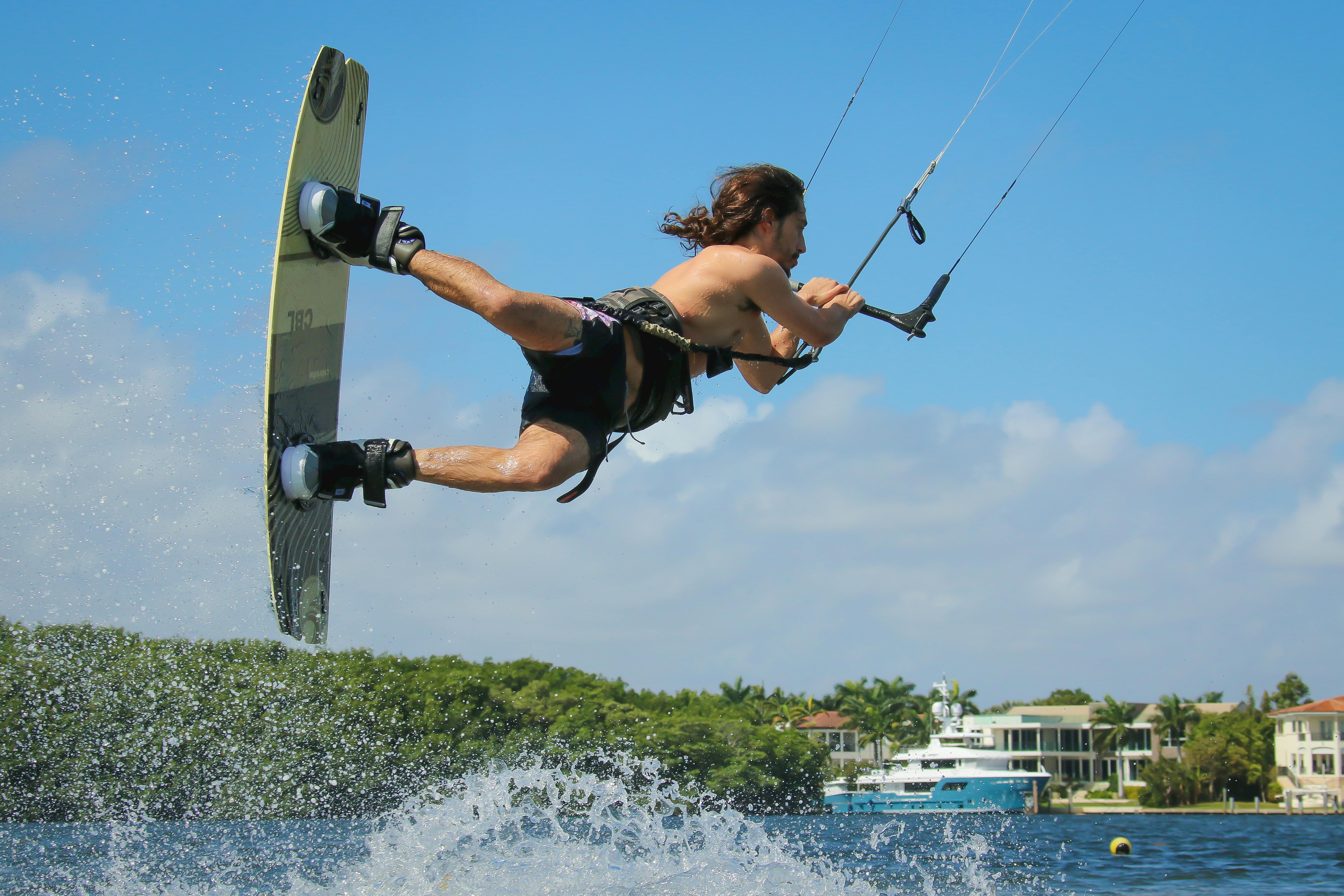 Thrilling wakeboarding stunt captured midair in the sunny waters of Miami, Florida.
