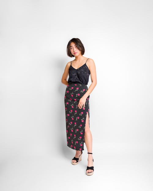 Studio Shot of a Woman in a Long, Floral Skirt, Black Top and Heels 
