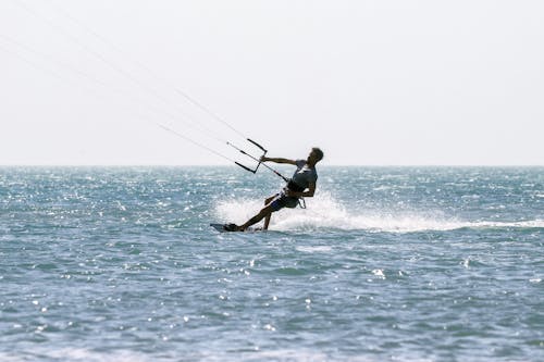 A Man Kitesurfing in the Ocean