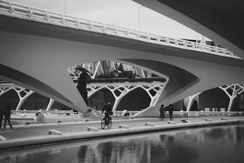 Cyclist Under Modern Bridge