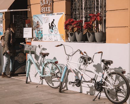 Bicycles parked outside a rental shop in Valencia, Spain on a sunny day.