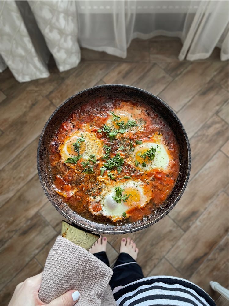 Hand Holding Pan With Shakshuka