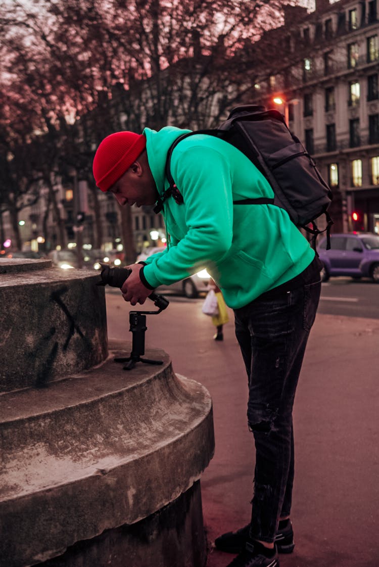 Man Taking A Photo In City