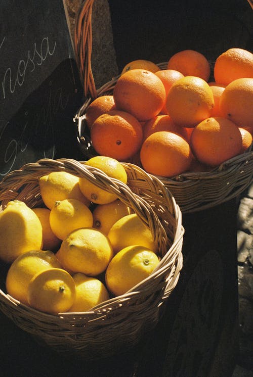 Wicker Baskets with Lemons and Oranges at the Stall