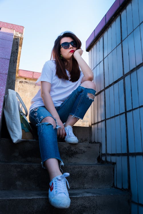 Free Woman Sitting On Stairs Beside Tote Bag Stock Photo