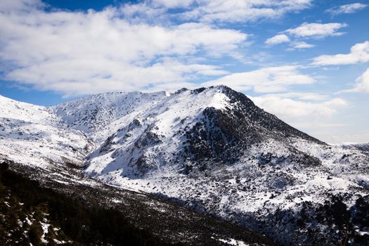 Discover the serene winter landscape of snowcapped mountains in Bouïra, Algeria.