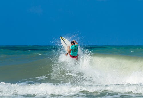 Free Man Surfboarding on Ocean Stock Photo