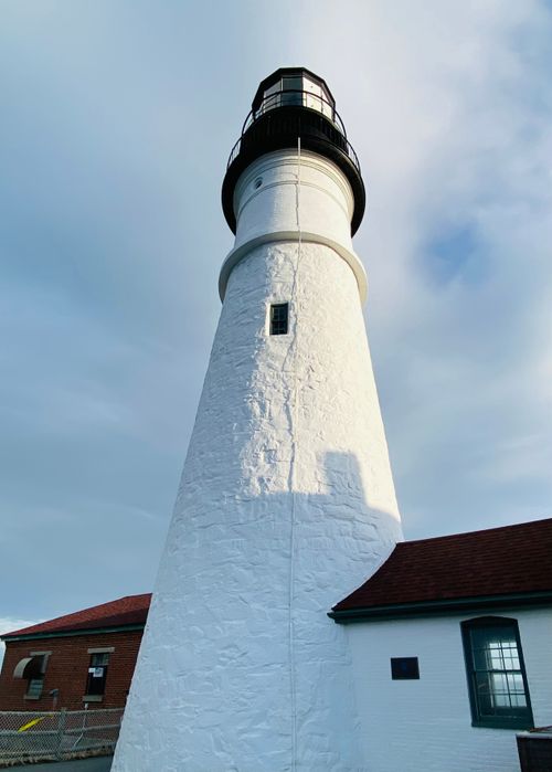 Free A stunning view of the iconic Portland Head Light at Cape Elizabeth, Maine under a clear sky. Stock Photo