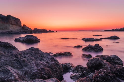 Rocks on Sea Shore at Sunset