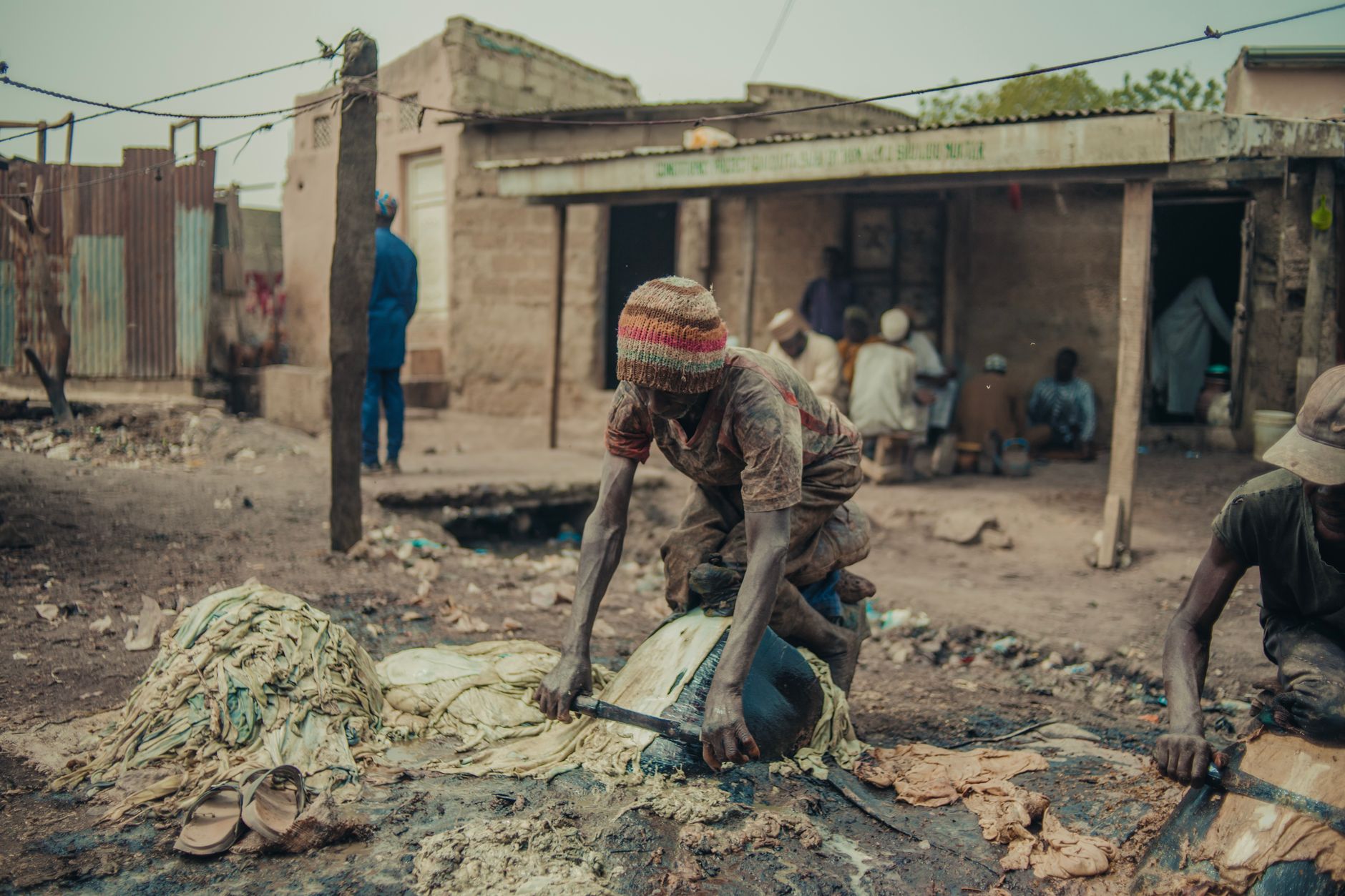 A man skillfully working in a rural Kano village in Nigeria, showcasing traditional craftsmanship.