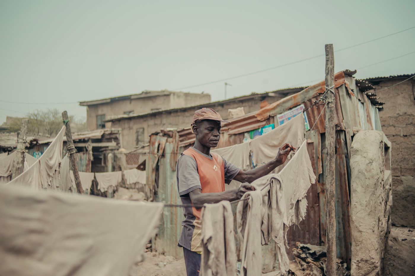 A man hanging laundry to dry in the sun