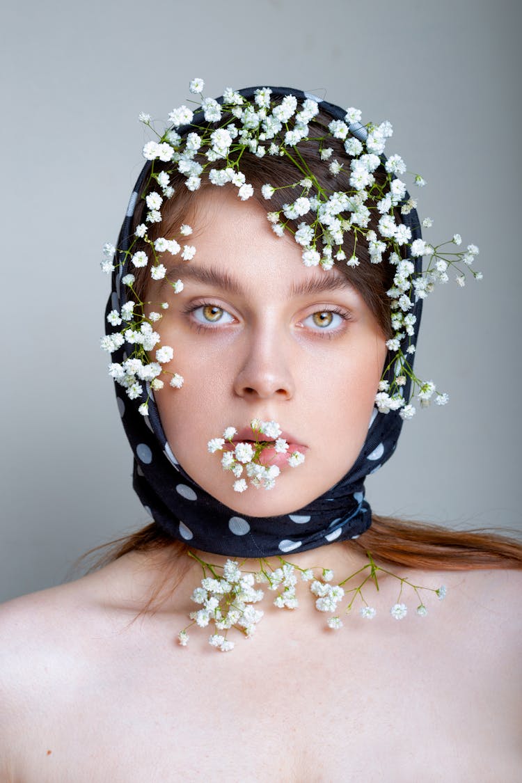 Portrait Of A Woman In A Headscarf With Flowers Tucked In It 