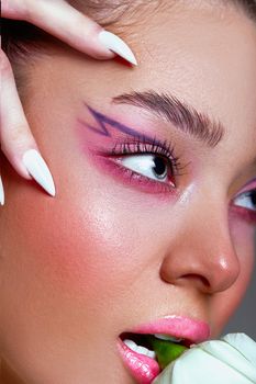 Close-up portrait featuring bold makeup and artistic design, highlighting beauty and elegance.