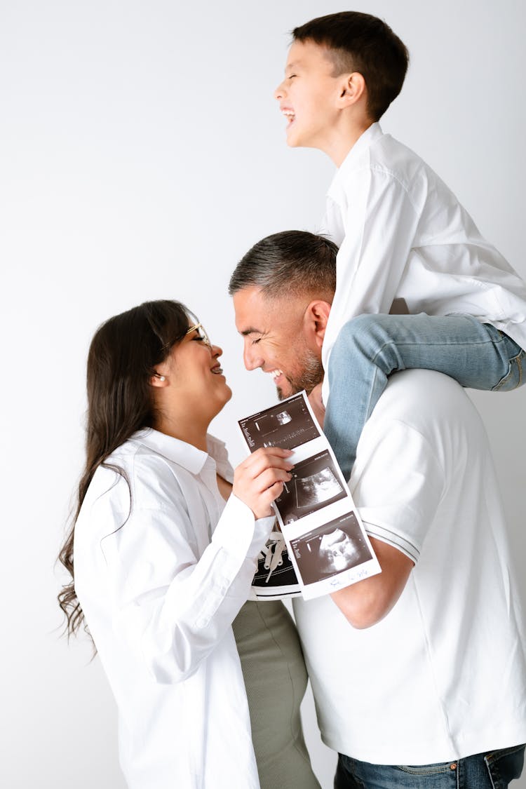 Happy Family With Ultrasound Of Fetus