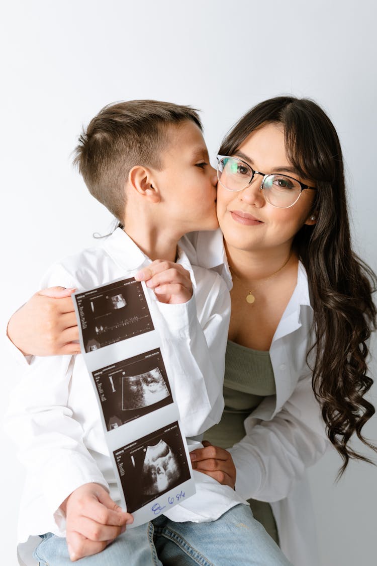 Mother And Son Showing Ultrasound During Pregnancy